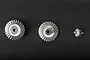 Three metal differential bevel gears of varying sizes arranged horizontally on a dark background.