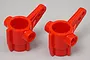 Two bright red plastic RC steering hub uprights for Tamiya models, shown against a plain grey background.