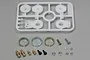 Tamiya Hi-Torque Servo Saver Horn Set parts including a white plastic parts tree, metal springs, ball studs, screws, and nuts on a grey surface.