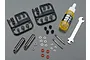 Tamiya 1/14 scale truck aluminium shock absorber kit including two shock bodies, shafts, oil, plastic parts trees, and a small wrench.