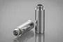 Two silver aluminium RC shock absorber bodies with threaded ends, displayed on a reflective grey surface.