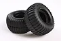 Two black Tamiya RC buggy rear tyres with a ribbed sand tread pattern, shown against a white background.