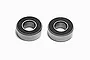 Two Tamiya 5x11x4mm rubber shielded ball bearings shown side by side against a white background.