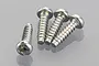Four silver-coloured metal binder head screws with coarse threads arranged on a reflective grey surface.