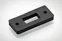 A black rectangular rubber switch seal with a central rectangular cutout and two mounting holes on a white background.