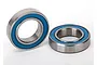 Two Traxxas rubber shielded ball bearings with blue seals on a white background.