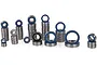 A collection of various sized metal ball bearings with blue rubber seals, arranged in stacks on a white background.