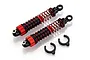 Two red and black RC shock absorbers with two black plastic spring spacers on a white background.