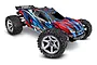 Traxxas Rustler 4x4 VXL RC stadium truck with a blue, red, and black graphic body, large off-road tires, and silver wheels on a white background.