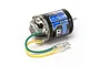 Tamiya TR Torque Tuned 540 brushed motor with green and yellow wires and bullet connectors against a white background.