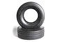 Two black Tamiya 1/14 scale RC truck front tyres stacked on a white background.