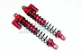 Two GPM Racing red anodized aluminium RC shock absorbers with external reservoirs, shown against a white background.