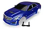 A blue Traxxas 1/10 scale Cadillac CTS-V painted RC car body shell with a black plastic body mount component on a white background.