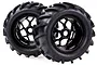 Two black RC monster truck wheels with deep-tread off-road tyres and six-spoke rims, isolated on a white background.