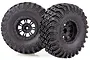 Two black 2.2 inch RC crawler wheels with aggressive off-road tread patterns and black plastic rims, isolated on a white background.