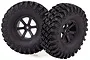 Two black 1.9-inch RC crawler wheels with aggressive off-road tread patterns on black six-spoke rims.