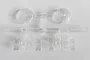 A clear plastic sprue containing headlight and turn signal lenses for an RC vehicle, featuring molded grid patterns and part numbers.