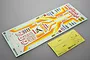 A Tamiya Hornet RC car decal sheet and a separate yellow window masking sheet on a grey background.