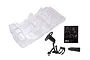 An unpainted clear plastic interior shell for a 1/10 scale RC car, including a steering wheel, gear shifters, and a dashboard decal sheet.
