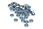 A collection of various sizes of metal ball bearings with blue rubber seals scattered on a white background.