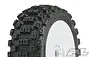 A close-up of a Pro-Line Badlands MX tyre mounted on a white dish rim, showing the aggressive block tread pattern.