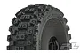 A close-up of a Pro-Line Badlands MX tyre mounted on a black dish rim, showing the aggressive block tread pattern and Pro-Line branding.