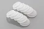 Ten translucent white rubber shock cap seals arranged in two rows on a grey surface.