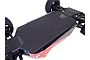 A black T-Bone Racing chassis skid plate installed on the underside of an ARRMA RC vehicle, showing the flat protective surface and mounting screws.
