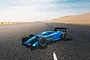 An ARRMA Limitless 1/7 scale RC car with a matte blue body shell parked on an asphalt road in a desert landscape.