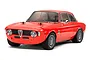 A studio shot of a red Tamiya Alfa Romeo Giulia RC car, showing the front three-quarter view against a white background.