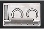 A Tamiya 1/35 scale photo-etched metal detail parts set for the M1A1/A2 Abrams tank, featuring mesh and circular components on a flat metal sheet.