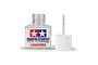 A bottle of Tamiya Plastic Cement with its white cap and attached applicator brush sitting beside it on a white background.