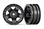 Two black Traxxas TRX-4 Sport 1.9-inch RC crawler rims shown from front and side angles against a white background.