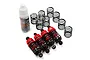 A set of four red aluminium RC shock absorbers with extra springs and a bottle of Yeah Racing silicone damper oil on a white background.