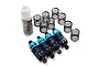 A set of four blue aluminium RC shock absorbers with black springs and a bottle of Yeah Racing silicone damper oil on a white background.