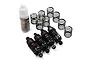 A set of four black aluminium RC shock absorbers with extra springs and a bottle of Yeah Racing silicone damper oil on a white background.