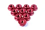 A collection of ten red anodized aluminium flanged serrated nuts arranged in a triangle formation against a white background.