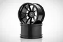 Two black plastic RC truck rims stacked on a white background.