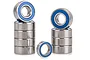 A set of nine metal ball bearings with blue rubber seals arranged in two stacks and one standing upright on a white background.