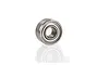 A single metal shielded ball bearing for RC vehicles, shown at an angle against a white background with a soft reflection.