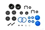 A collection of small black, blue, and metal RC shock rebuild parts including pistons, seals, o-rings, and screws on a white background.