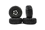 A set of four black RC crawler wheels with aggressive tread patterns and black five-spoke metal rims against a white background.