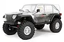 Axial SCX10 III Jeep Wrangler Rubicon JLU RC rock crawler kit with an unpainted clear polycarbonate body shell on a white background.