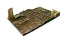A 1/35 scale diorama base by Vallejo featuring a weathered country road crossing with railway tracks and ruined brick wall sections.