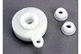 A white plastic Traxxas servo saver assembly with two additional small splined servo horn adapters on a grey textured background.
