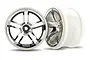 Two Traxxas 2.8-inch twin-spoke RC truck rims with a chrome finish and white plastic inner barrels.