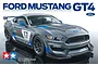 Box art for Tamiya 1/24 scale Ford Mustang GT4 plastic model kit showing a grey race car with blue accents and number 17 on a white background.