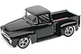 A high-angle studio shot of a completed black Revell 1/25 scale Foose Ford F-100 pickup truck model kit on a white background.