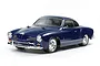 A studio shot of a 1/10 scale Tamiya Volkswagen Karmann Ghia RC car model, finished in a glossy dark blue paint with chrome bumpers and wheels.