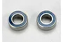 Two Traxxas 5x10x4mm rubber shielded ball bearings shown side by side on a light grey surface.